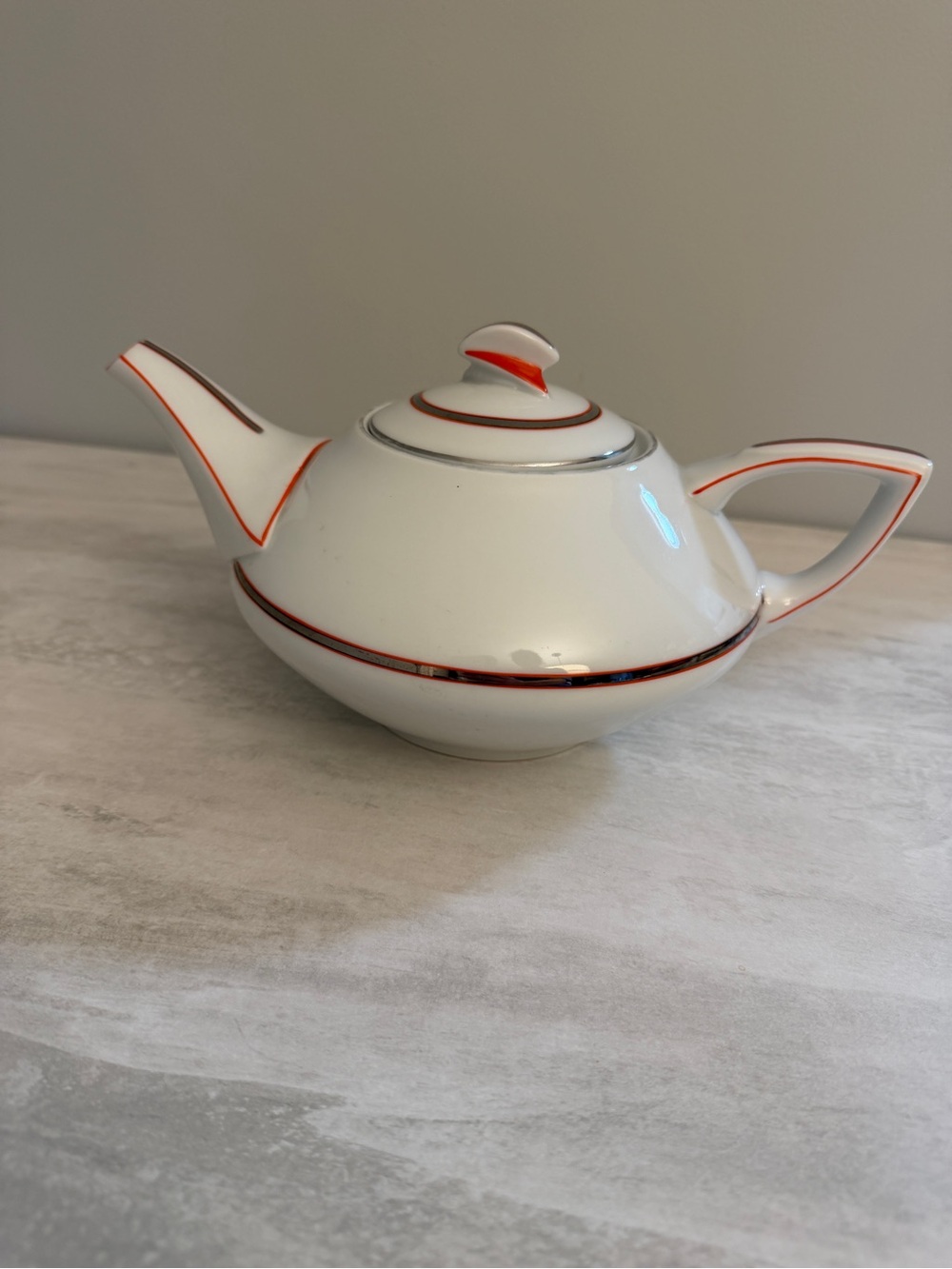 MCM teapot. White with poppy red/orange and silver accents.  10.5” x 4”